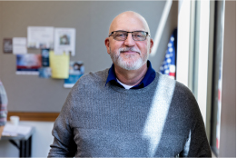 proud vet standing in front of flag