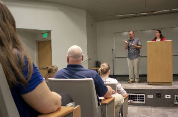 A person interpreting for speaker on stage