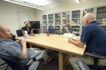 people sitting around table in Interpreter Lab